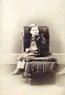 Old photo of toddler boy sitting on couch clear iamge