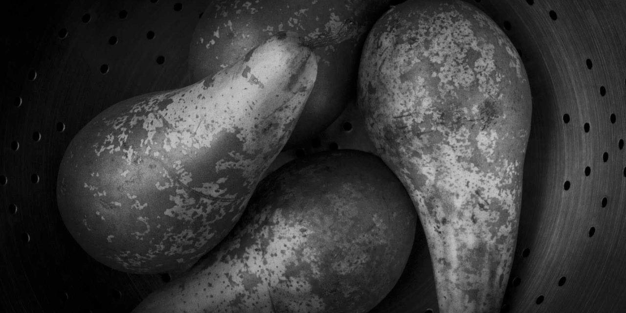 Four pears inside an utensil